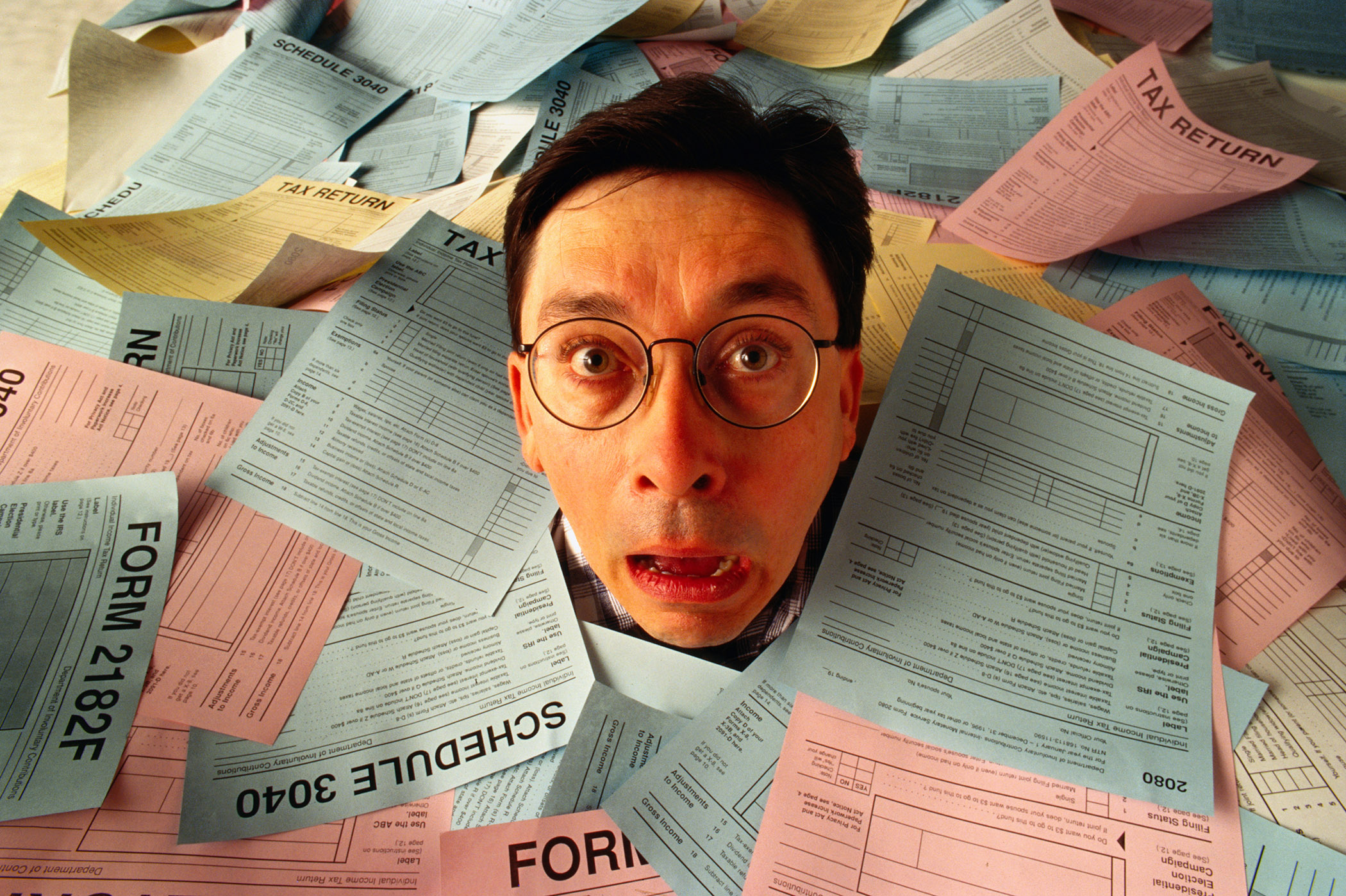 MAN IN SEA OF TAX FORMS