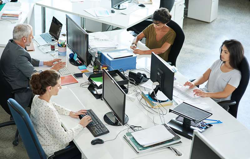 Shot of a group of coworkers sitting at their workstations
