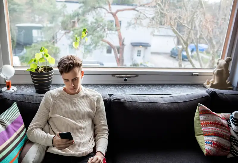 Millennial sitting on couch