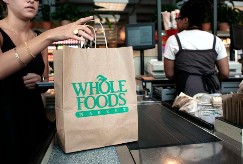 A customer checks out of a Whole Foods Market in Washington,