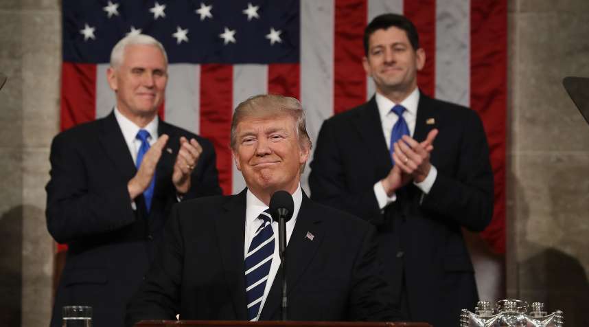 U.S. President Donald Trump, center, smiles as U.S. Vice President Mike Pence, left, and U.S. House Speaker Paul Ryan, a Republican from Wisconsin, applaud during a joint session of Congress in Washington, D.C., U.S., on Tuesday, Feb. 28, 2017.