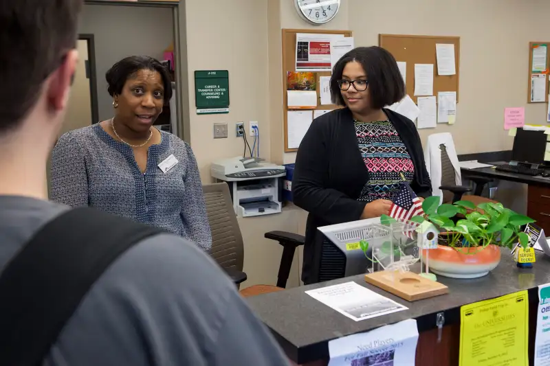 A student (r.) works in the counseling office at Frederick Community College on a work-study program to avoid student debt, on October 6, 2015 in Frederick, Maryland. She thinks that a college education is essential. She hopes to work in the health care field when she graduates. People living in this small city have a median income a bit above the national median. Its homeownership rate is a bit below average.