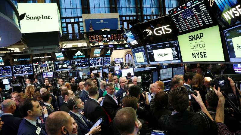 Traders on the floor of the New York Stock Exchange (NYSE) wait for Snap Inc to post their IPO in New York, March 2, 2017.