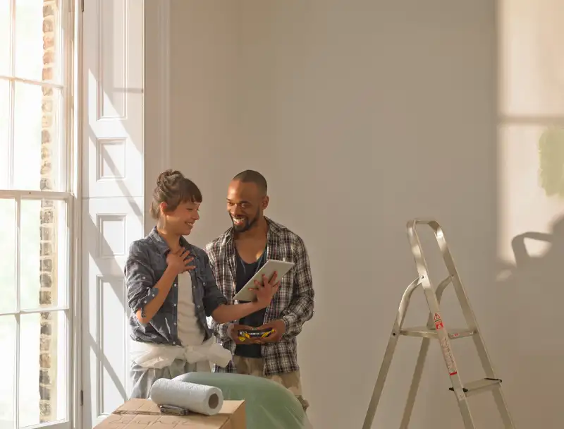 A couple discussing DIY looking at an iPad
