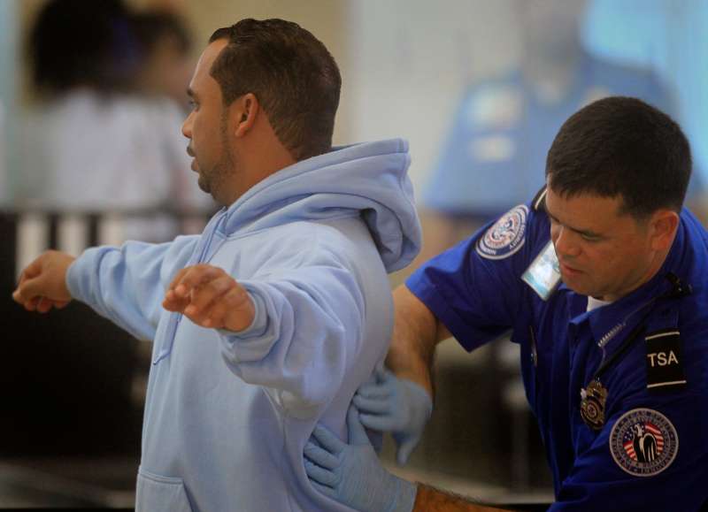 A TSA agent conducts a secondary inspection and patdown after the traveler kept setting off the me