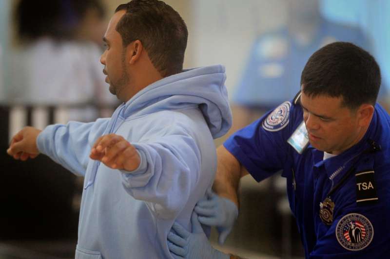 A TSA agent conducts a secondary inspection and pat-down after the traveler kept setting off the metal detector at John Wayne Airport in Santa Ana, during the Thanksgiving getaway Wednesday, November 24, 2010.