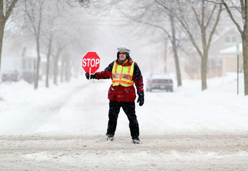 School crossing guard on a snowy Wisconsin street