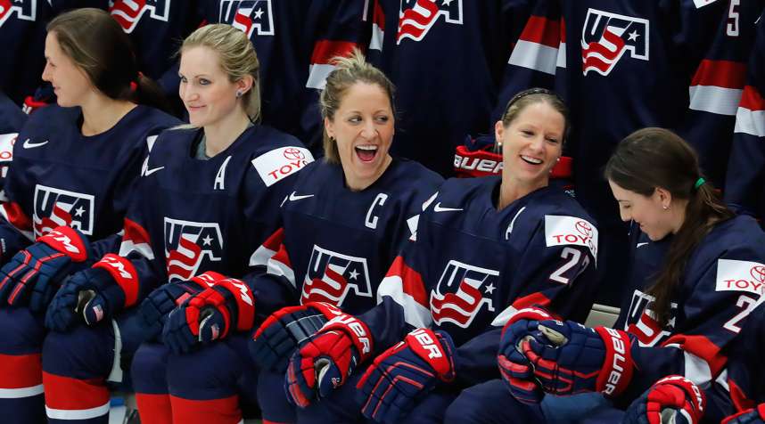 United States captain Meghan Duggan, laughs with Kacey Bellamy during a team photo in preparation for the IIHF Women's World Championship hockey tournament, Thursday, March 30, 2017, in Plymouth, Mich.