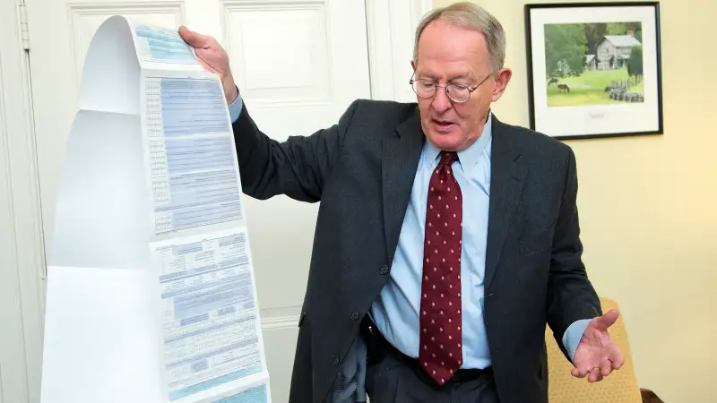 Sen. Lamar Alexander, R-Tenn., shows the Free Application for Federal Student Aid (FAFSA) form, during an interview with the Associated Press on Capitol Hill in Washington, Friday, Nov. 14, 2014.