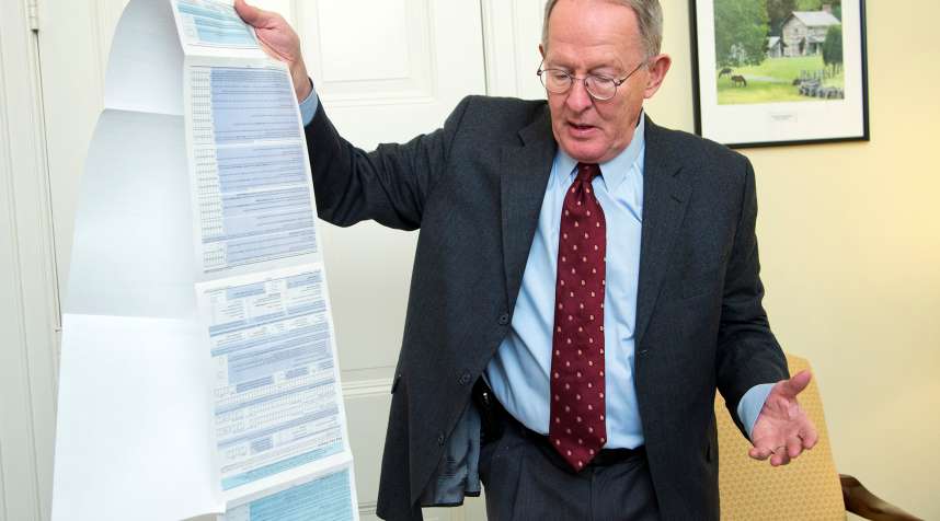 Sen. Lamar Alexander, R-Tenn., shows the Free Application for Federal Student Aid (FAFSA) form, during an interview with the Associated Press on Capitol Hill in Washington, Friday, Nov. 14, 2014.