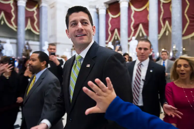 House Speaker Paul Ryan of Wisc., passes a waving tourist as he walks from the House Chamber to his office on Capitol Hill in Washington, Friday, March 24, 2017.