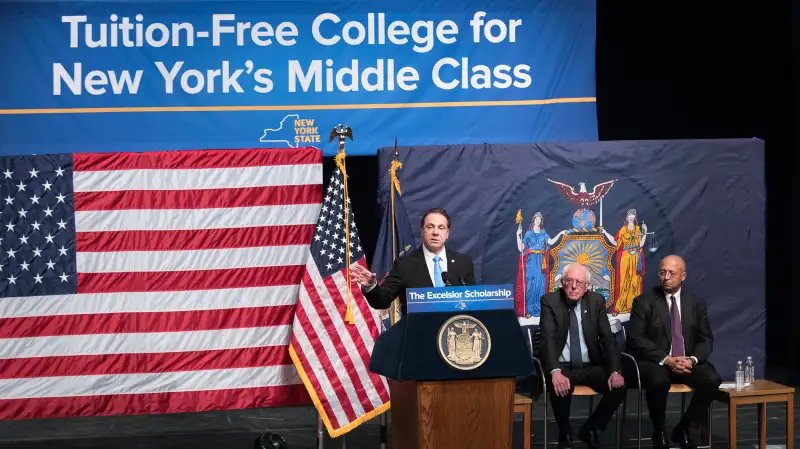 New York Gov. Andrew Cuomo, left, is joined by Vermont Sen. Bernie Sanders, center, and Chairperson of the Board of Trustees of The City University of New York William C. Thompson, as he speaks during an event at LaGuardia Community College, Tuesday, Jan. 3, 2017, in New York. Gov. Cuomo announced a proposal for free tuition at state colleges to hundreds of thousands of low- and middle income residents. Under the governor's plan, which requires legislative approval, any college student accepted to a New York public university or two-year community college is eligible, provided their family earns less than $125,000.