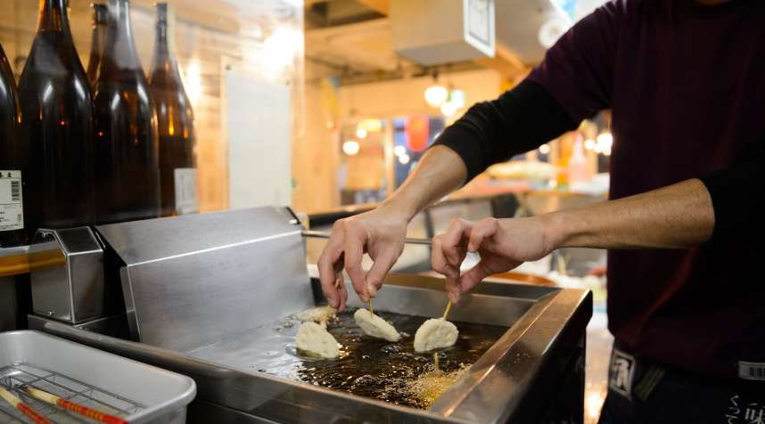 An employee fries Kushikatsu at a Kushikatsu Tanaka restaurant in Tokyo, Japan.