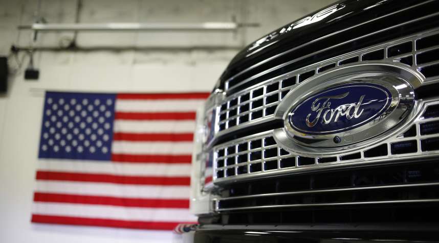 A 2017 Ford Motor Co. Super Duty F-250 truck stands near an American flag at the Ford Kentucky Truck Plant in Louisville, Kentucky, U.S., on Friday, Sept. 30, 2016.