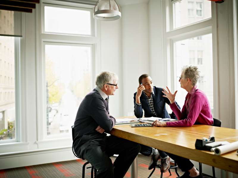 Coworkers in discussion in conference room