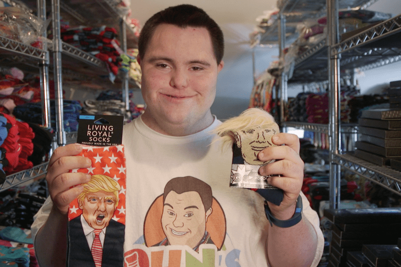 John Cronin holds up pairs of Donald Trump socks.