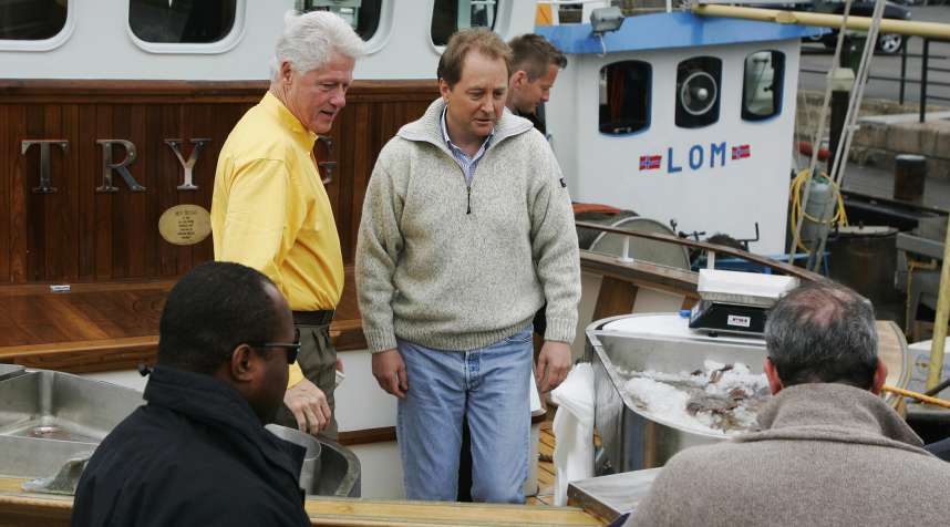 Former U.S. President Bill Clinton (L) and billionaire Kjell Inge Roekke are seen aboard the latter's shrimp trawler in Oslo, Norway.