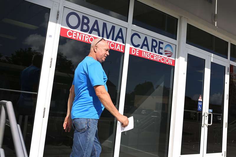 Alberto Abin walks out of the UniVista Insurance company office after shopping for a health plan under the Affordable Care Act, also known as Obamacare, on December 15, 2015 in Miami, Florida.