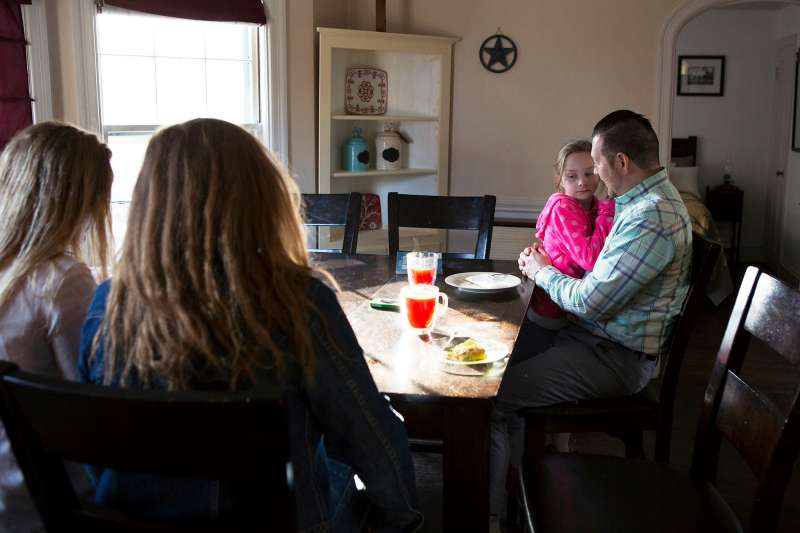 Nathan Bonds spends time at home with his daughters Courtney (15), Sierra (16), and Ava (7) before leaving for work.