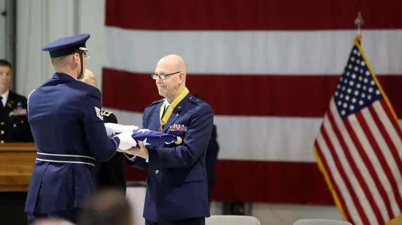 Brig. Gen. Brent Feick, outgoing director of joint staff for the Alaska National Guard, participates in a flag folding ceremony during his retirement ceremony at the National Guard armory on Joint Base Elmendorf-Richardson, Alaska, April 1, 2017. Feick retired after 41 years of service to our nation.