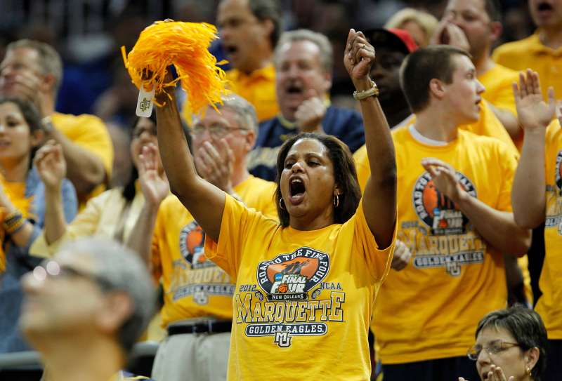 Marquette University fans cheer for their team against Murray State University in their NCAA basketball game in Louisville, Kentucky March 17, 2012.