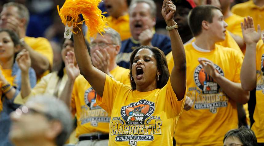 Marquette University fans cheer for their team  in Louisville, Kentucky March 17, 2012.