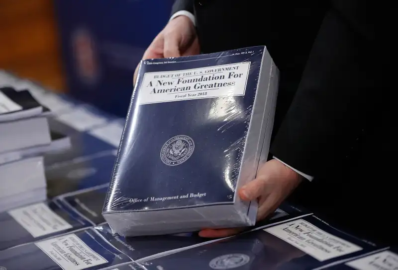 Eric Ueland, Republican staff director, Senate Budget Committee holds a copy of President Donald Trump's fiscal 2018 federal budget, before distributing them to congressional staffers on Capitol Hill in Washington, Tuesday, May 23, 2017.