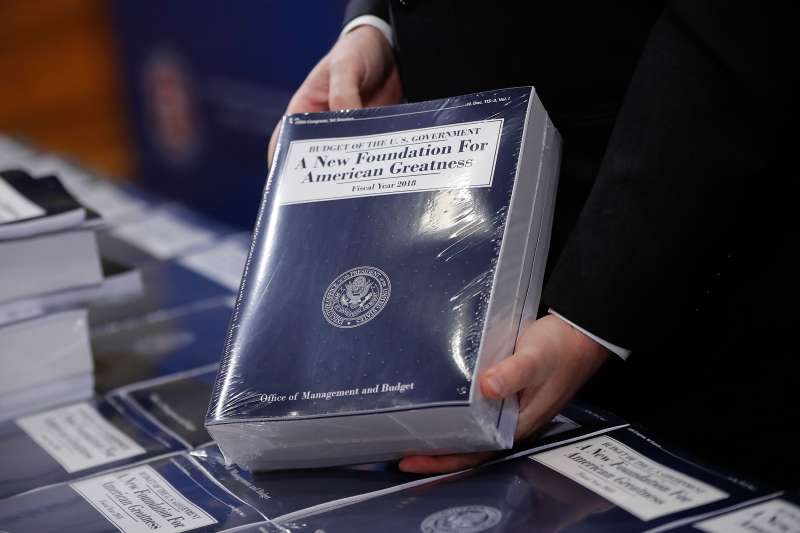 Eric Ueland, Republican staff director, Senate Budget Committee holds a copy of President Donald Trump's fiscal 2018 federal budget, before distributing them to congressional staffers on Capitol Hill in Washington, Tuesday, May 23, 2017.