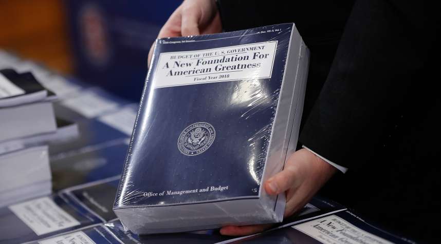 Eric Ueland, Republican staff director, Senate Budget Committee holds a copy of President Donald Trump's fiscal 2018 federal budget, before distributing them to congressional staffers on Capitol Hill in Washington, Tuesday, May 23, 2017.