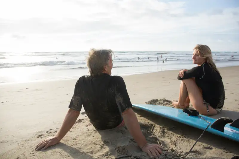 Father and daughter converse, after surfing