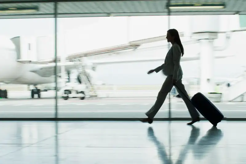 Businesswoman with suitcase in airport