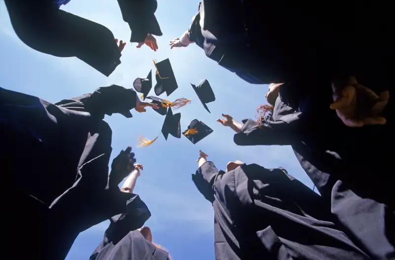 Graduates throwing their caps into the air