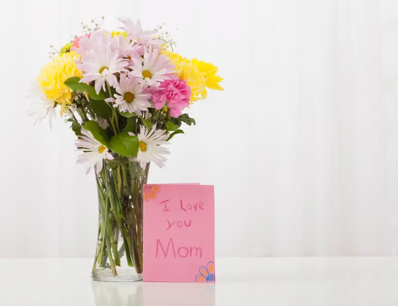 Bouquet in vase with greeting card for Mother's Day