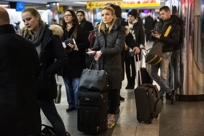 Travelers wait in a line at La Guardia Airport during a winter storm on February 2, 2015 in the Queens borough of New York City.