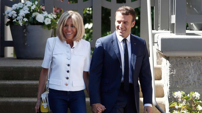 French President Emmanuel Macron and his wife Brigitte Macron leave their house in Le Touquet, northern France, before casting their votes in the first round of the two-stage legislative elections, Sunday, June 11, 2017.