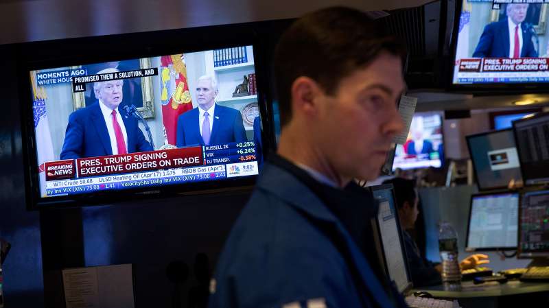 President Donald Trump is displayed on television monitors as traders work and financial professionals work on the floor of the New York Stock Exchange (NYSE) ahead of the closing bell, March 31, 2017 in New York City.