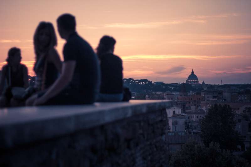 Italy, Rome, People watching the roman sunset at Giardino degli Aranci Peak