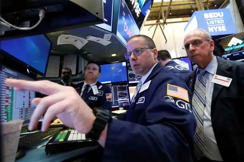 Traders work on the floor of the NYSE in New York