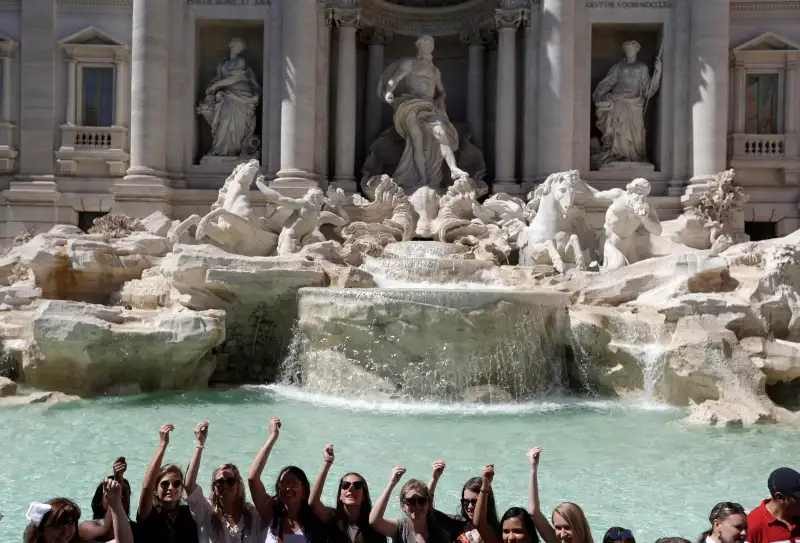 Tourists throw their coins in the Trevi Fountain in Rome, Wednesday, June 7, 2017.