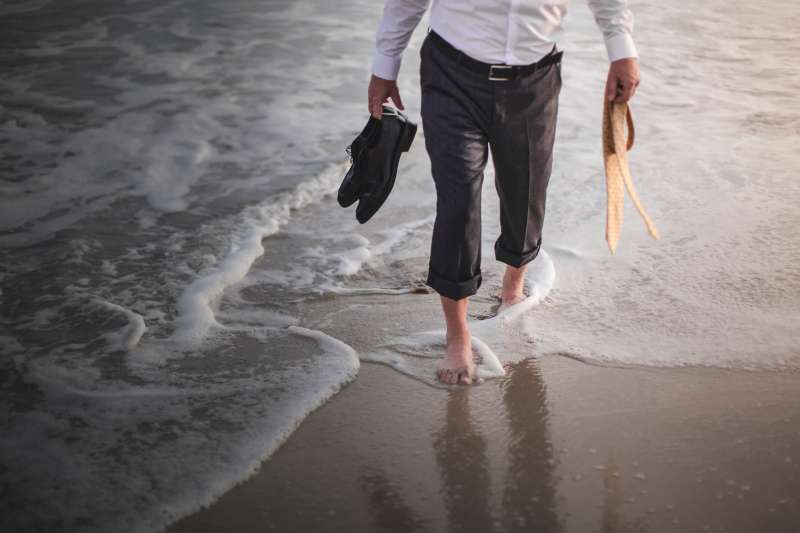 Retired businessman paddling in sea