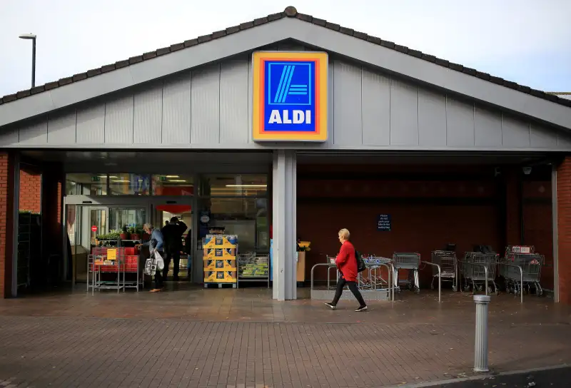 Shoppers enter a branch of the budget supermarket Aldi in Bristol, England.