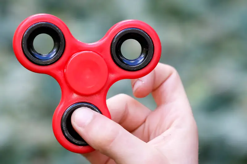 A child shows a  Hand Spinner,  on May 20, 2017 in Paris.