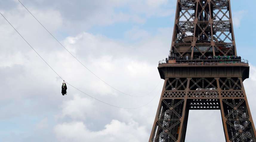 A person rides on a zip-line descending from the second floor of the Eiffel Tower to the Plateau Joffre on June 5, 2017 in Paris.