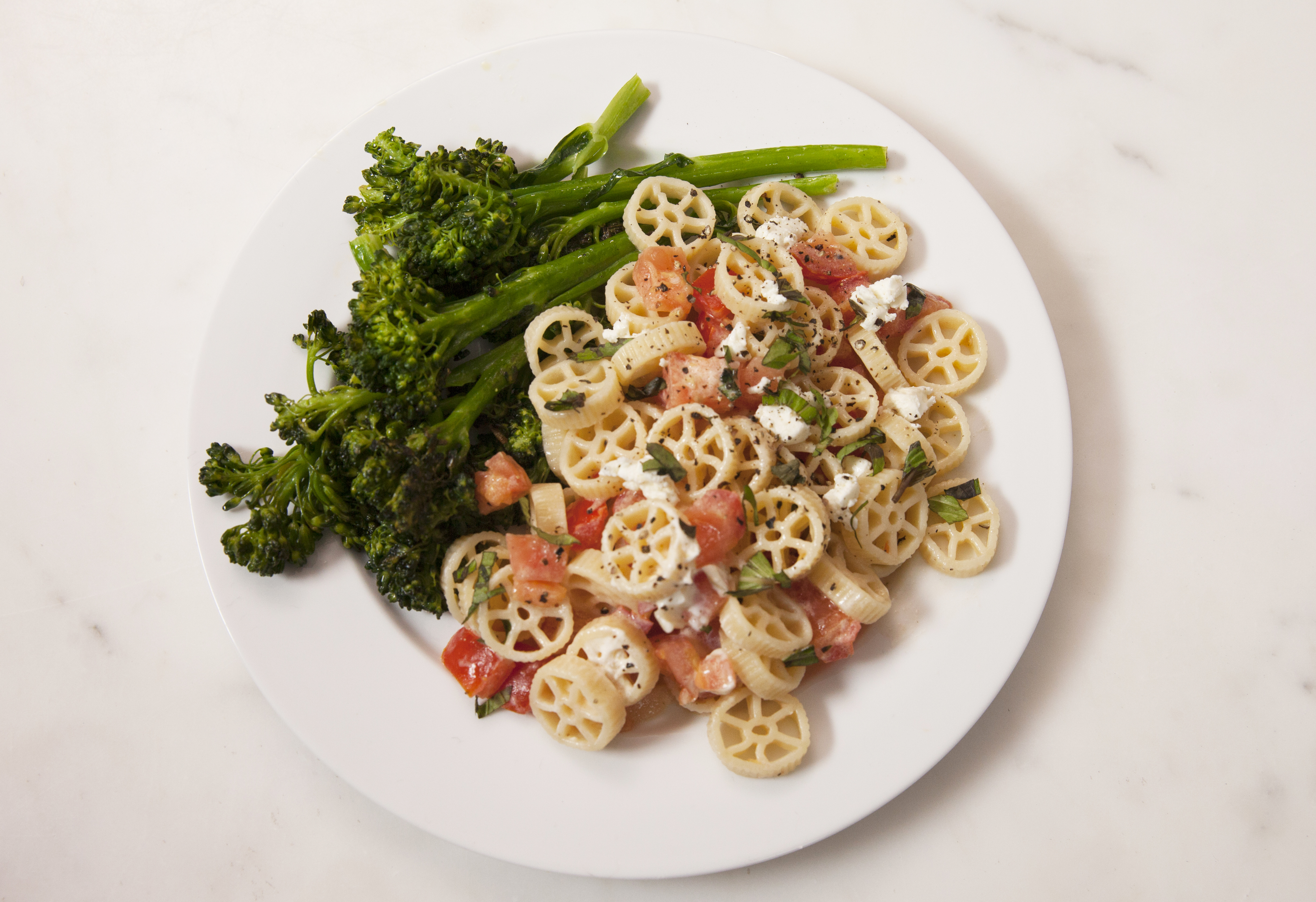 Marley Spoon's Creamy Wagon Wheel Pasta with tomatoes and garlicky broccolini.