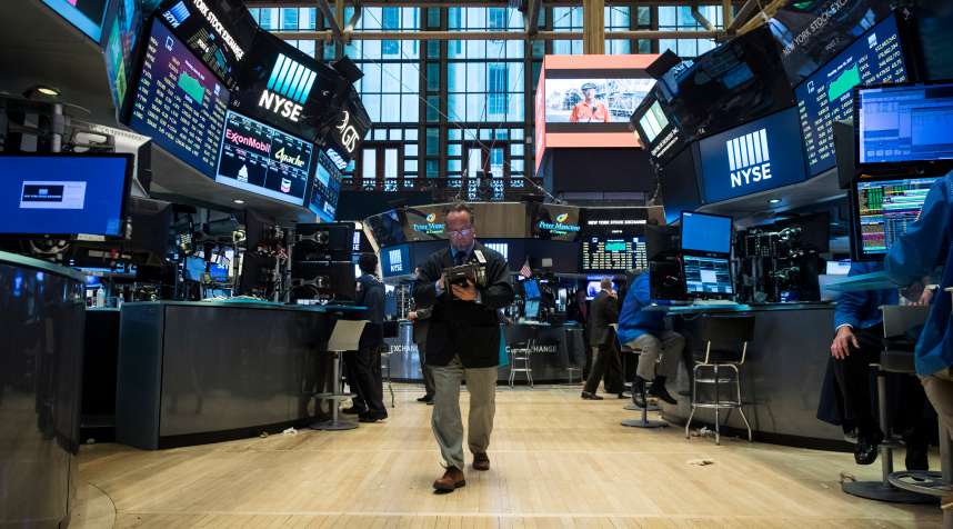 Traders and financial professionals work on the floor of the New York Stock Exchange (NYSE) ahead of the closing bell, June 19, 2017 in New York City.