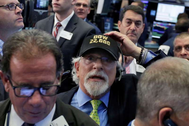 Trader Peter Tuchman, center, wears a  Dow 22,000  hat as he works on the floor of the New York Stock Exchange, August 2, 2017.