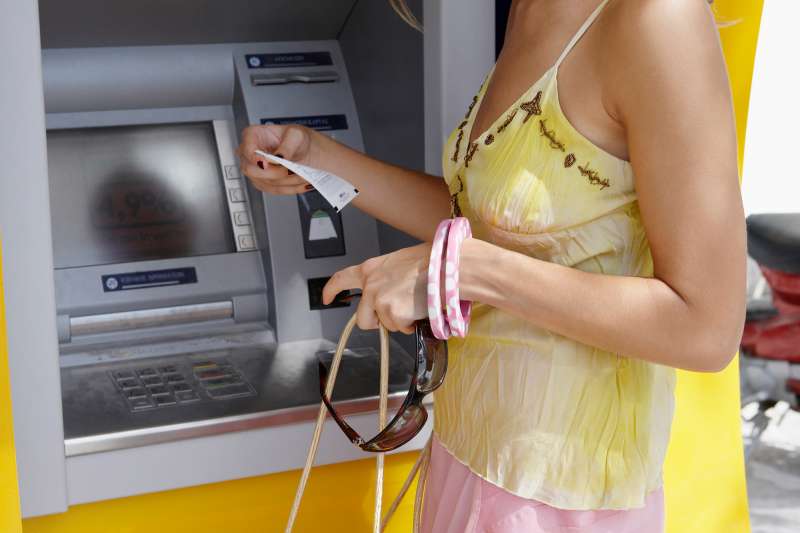 woman looking at atm receipt