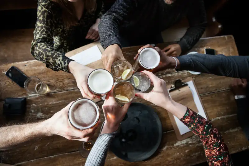 friends at a pub toasting