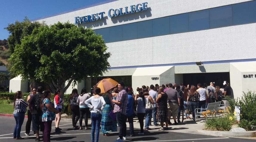 Students wait outside Everest College, Tuesday, April, 28, 2015 in Industry, Calif., hoping to get their transcriptions and information on loan forgiveness and transferring credits to other schools.