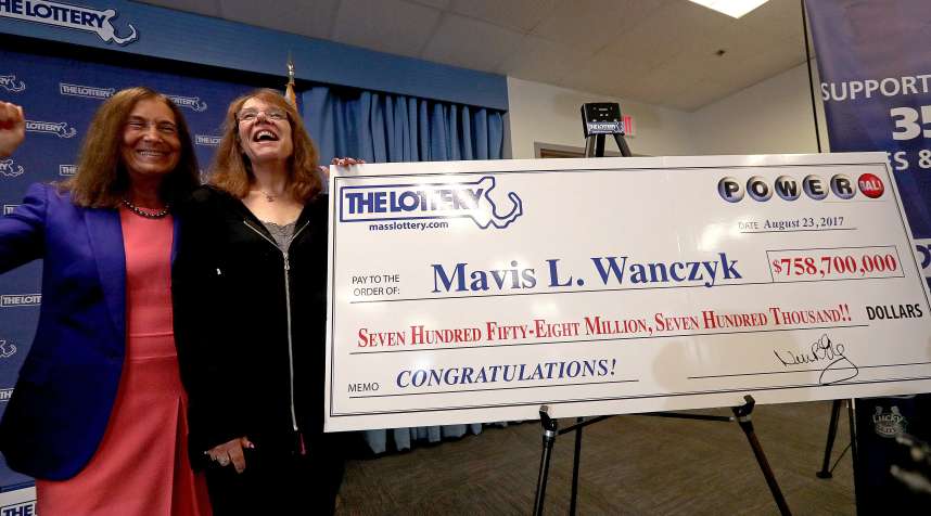 Winner of the $758.7 million Powerball jackpot Mavis L. Wanczyk, right, poses for a photo with Massachusetts State Treasurer Deborah Goldberg, left, in Braintree, Mass., Aug. 24, 2017.